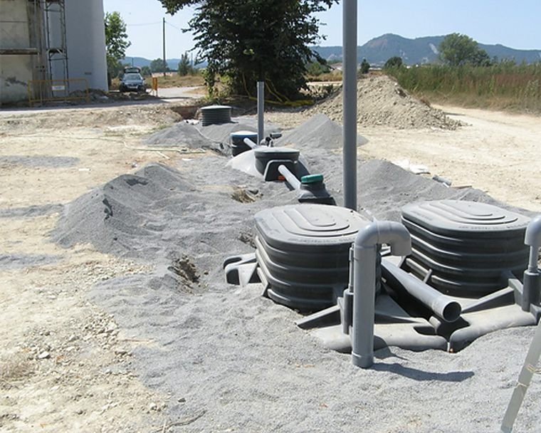 Packaged underground treatment tanks being installed on site
